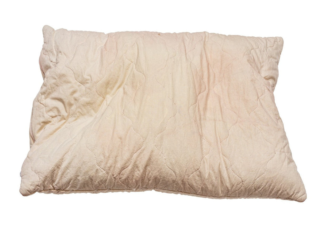 Pillow with yellow stains caused by long-term use and moisture build-up